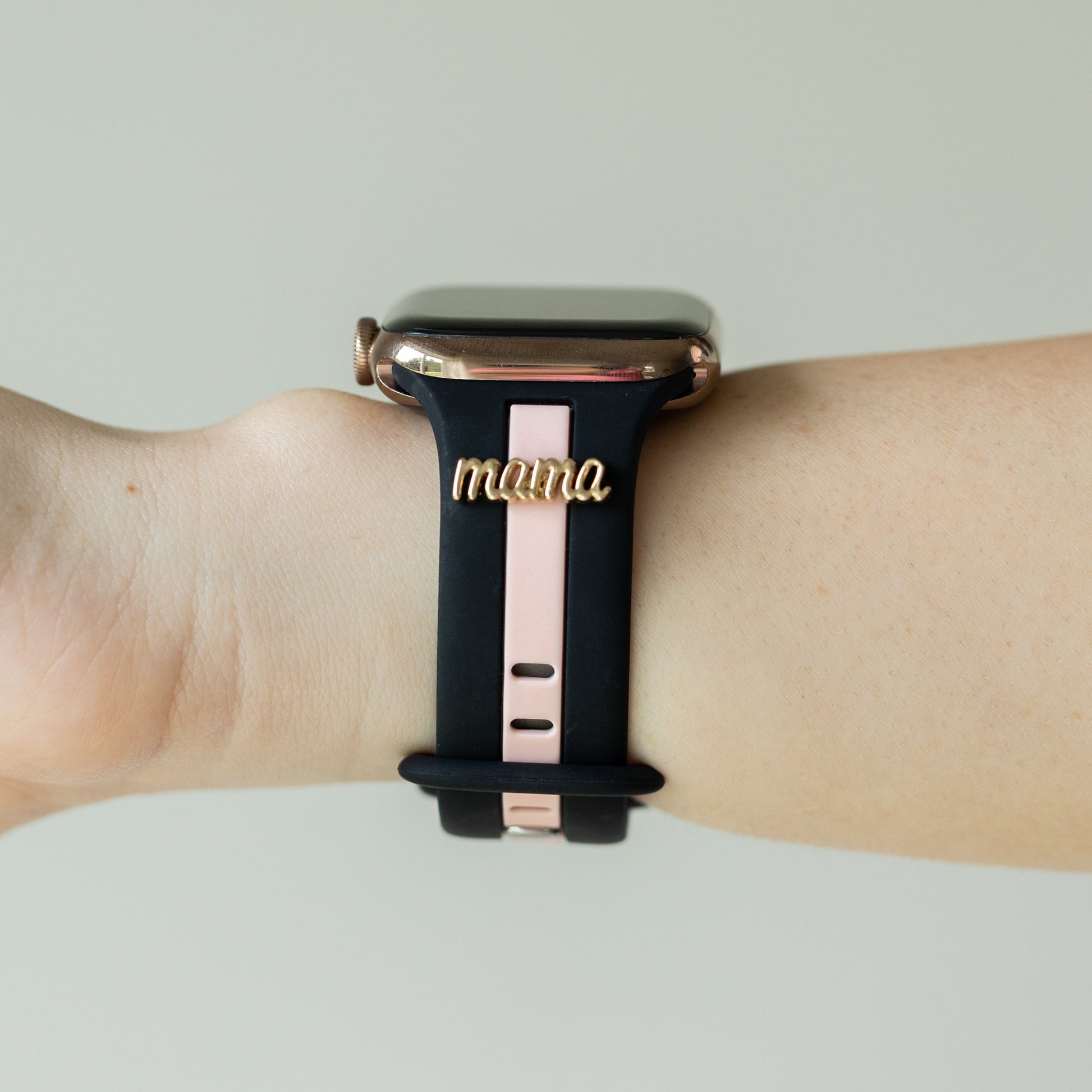 Smartwatch with a black band featuring the word 'mama' on a light background